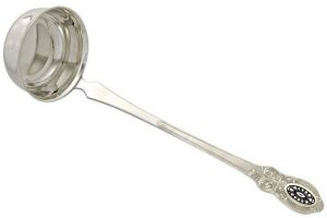 The spoon for pouring soup is silver