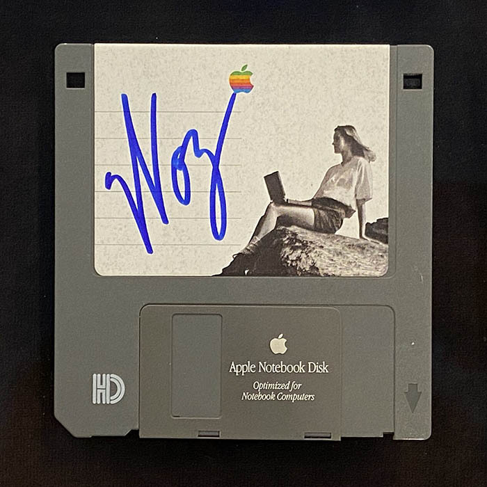 A floppy disk signed by Steve Wozniak, gray with a white sticker