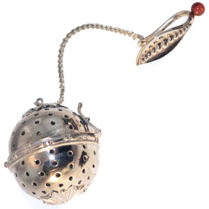 Silver tea strainer with amber